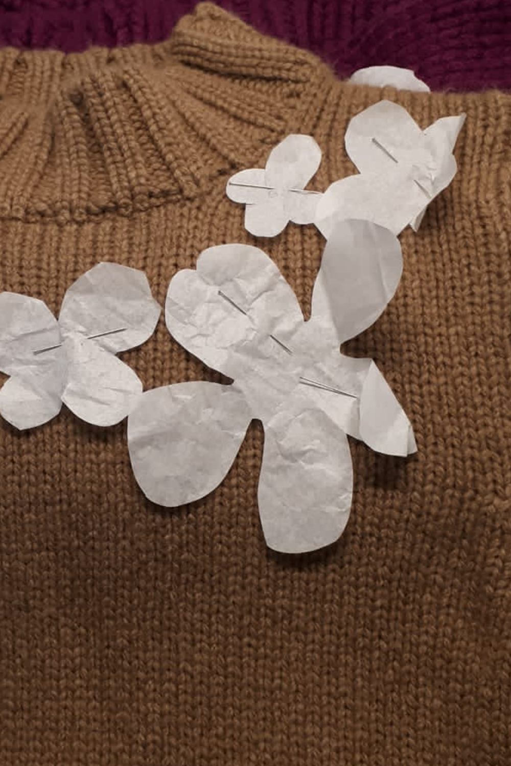 Cashmere knitwear in the design process – placing floral elements on a knitted piece.