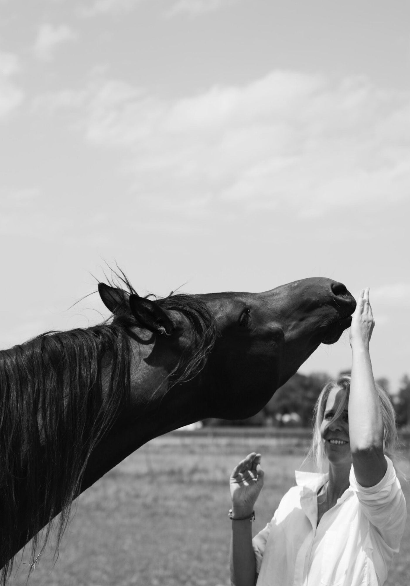 Antonia Zander with horse Juri in a quiet landscape – a moment of closeness, nature, and mindful luxury.