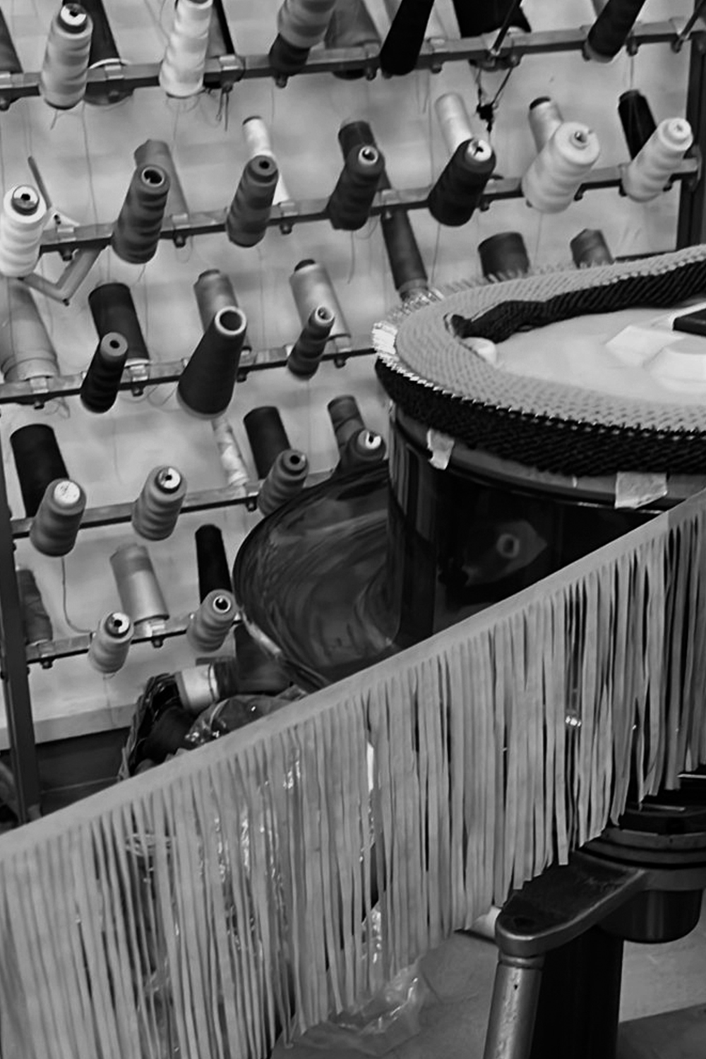 Triangolo production – the application of leather fringes.