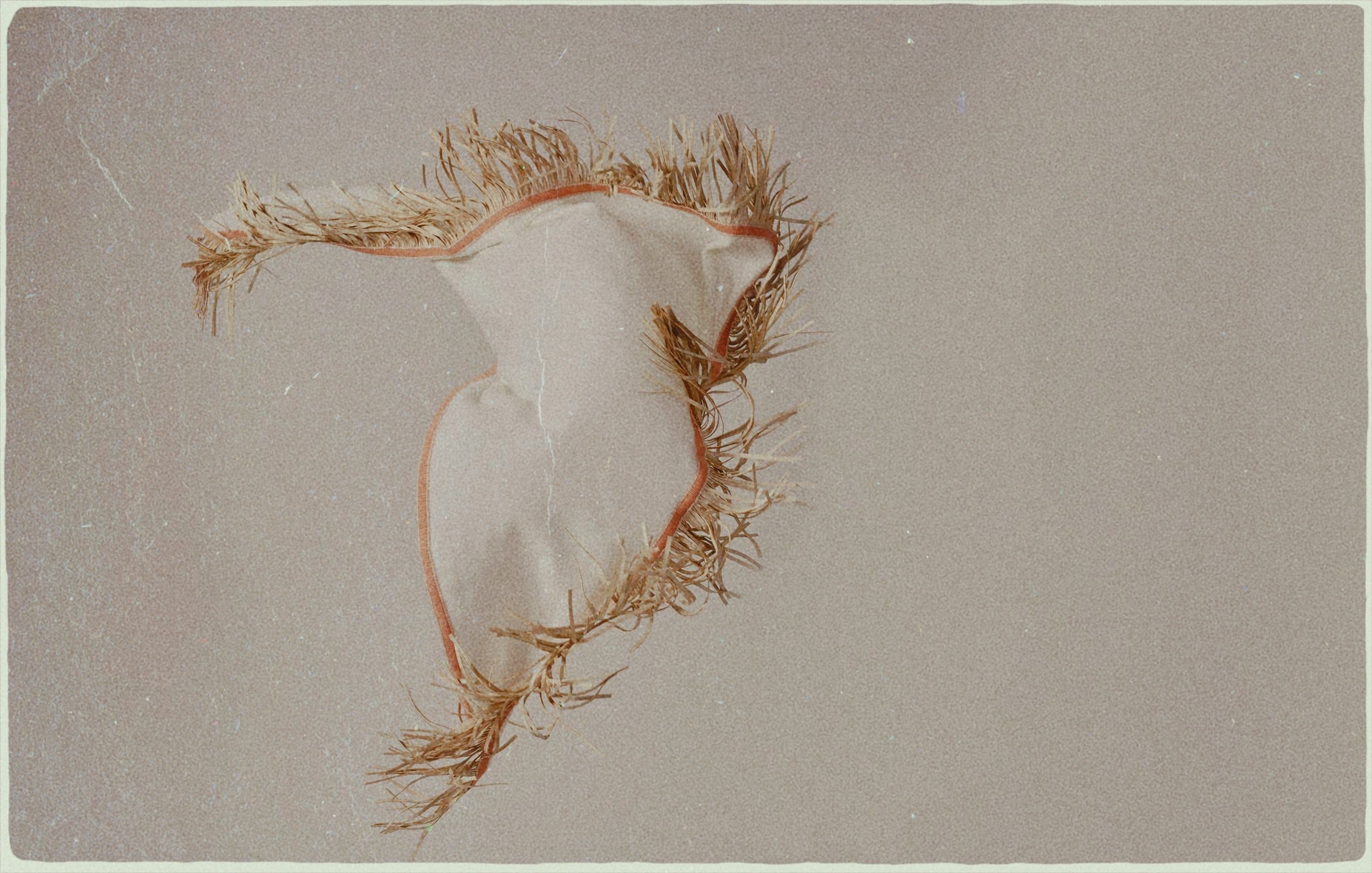 The Triangolo – a cashmere triangle scarf with leather fringe, crafted in Italy by Antonia Zander