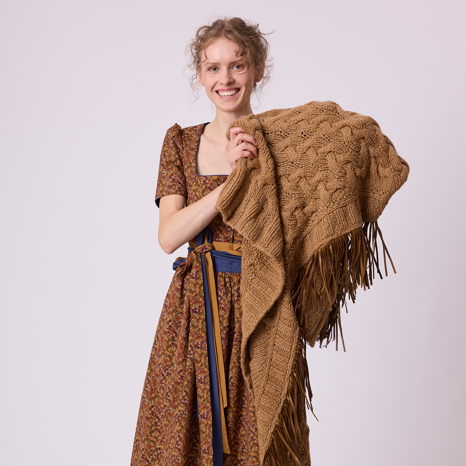 Hand-knitted Camoscio stola in cashmere with leather fringes, styled with a dirndl by Antonia Zander.