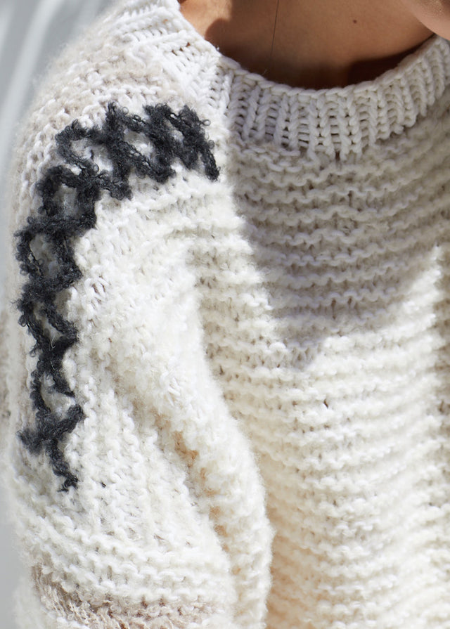 stunning details complete this fine handknit sweater 